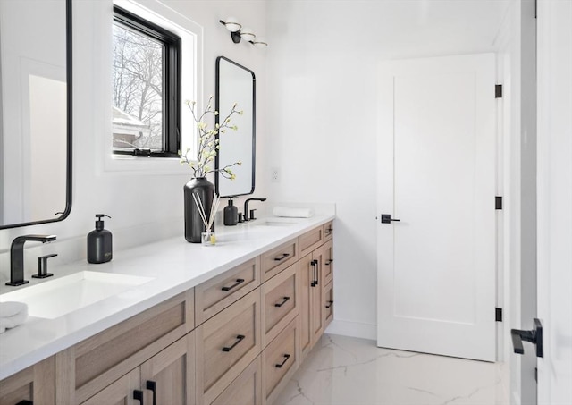 full bathroom with marble finish floor, double vanity, and a sink