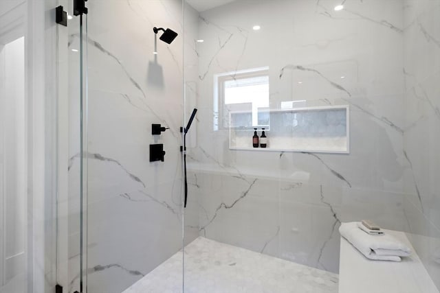 bathroom with a marble finish shower