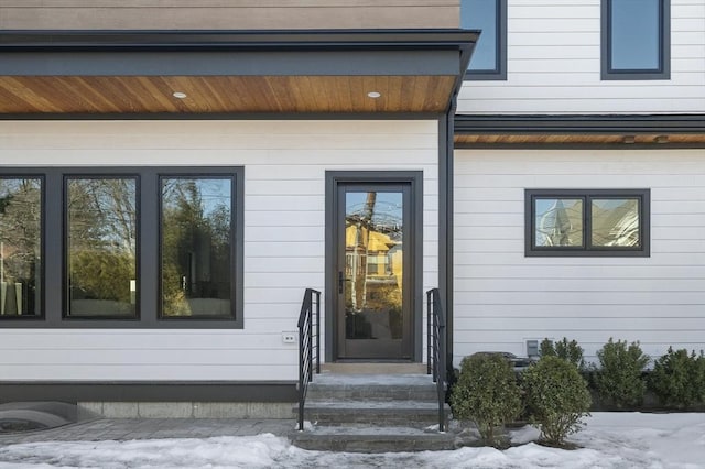 view of snow covered property entrance