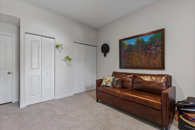 carpeted living room with baseboards