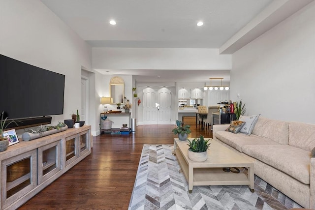living room with wood finished floors, baseboards, and recessed lighting