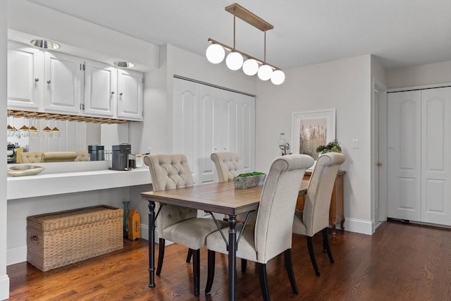 dining area with wood finished floors and baseboards