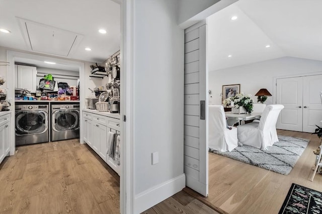 washroom featuring washer and clothes dryer and light hardwood / wood-style floors