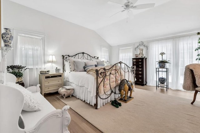 bedroom with lofted ceiling, light wood-type flooring, and ceiling fan