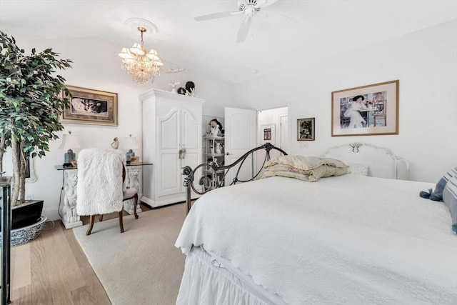 bedroom with ceiling fan, lofted ceiling, and light wood-type flooring