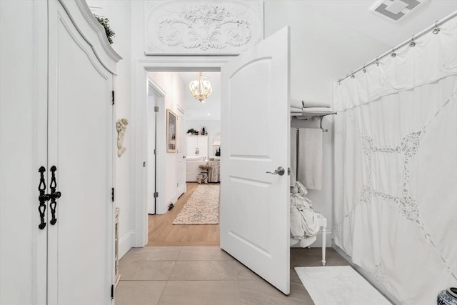 corridor featuring light tile patterned floors