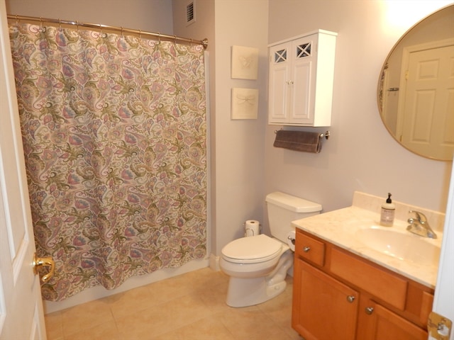 bathroom with toilet, curtained shower, vanity, and tile patterned floors