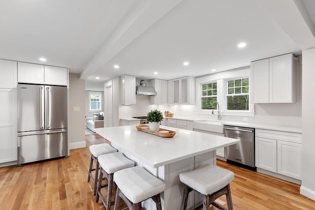 6 Ivy Cir, Winchester, MA 01890 - kitchen featuring appliances with stainless steel finishes, a kitchen bar, white cabinets, a center island, and recessed lighting
