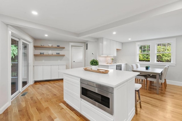 6 Ivy Cir, Winchester, MA 01890 - kitchen with stainless steel microwave, light countertops, white cabinetry, light wood-type flooring, and recessed lighting
