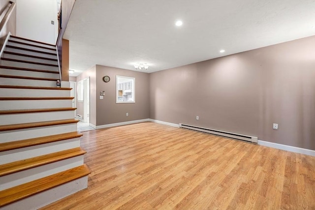 basement with light hardwood / wood-style floors and a baseboard radiator