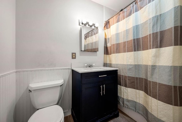 bathroom featuring walk in shower, vanity, and toilet