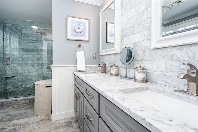 bathroom with vanity, an enclosed shower, and crown molding