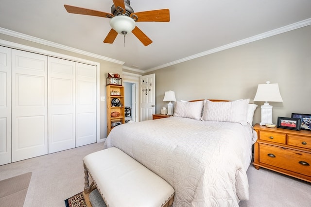 carpeted bedroom with ornamental molding, a closet, and ceiling fan