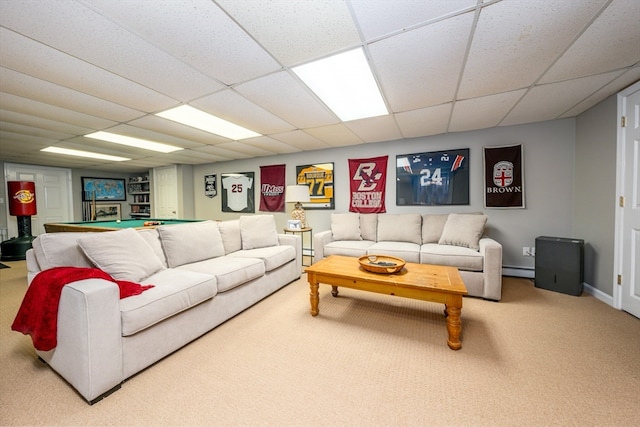 carpeted living room featuring a drop ceiling and baseboard heating