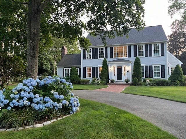 colonial home with a front yard