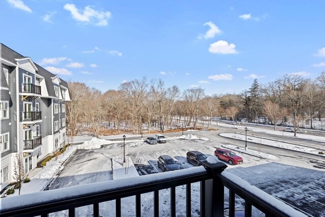 yard covered in snow featuring a balcony