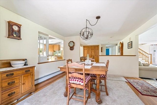 49 Karen Rd, Hanover, MA 02339 - dining room featuring a baseboard heating unit, a chandelier, light wood finished floors, and stairs