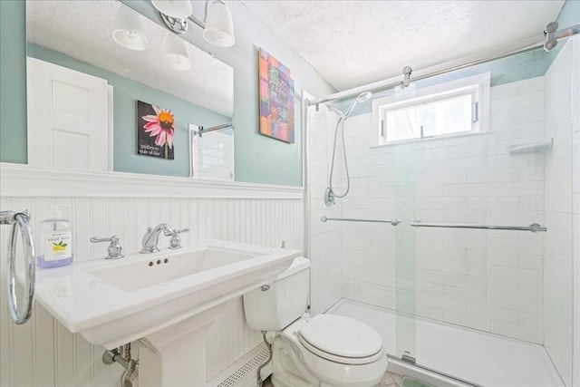 49 Karen Rd, Hanover, MA 02339 - full bathroom featuring toilet, tiled shower, wainscoting, a textured ceiling, and baseboard heating