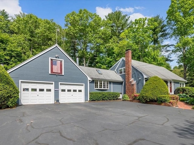 49 Karen Rd, Hanover, MA 02339 - view of front of home featuring asphalt driveway, a chimney, and an attached garage