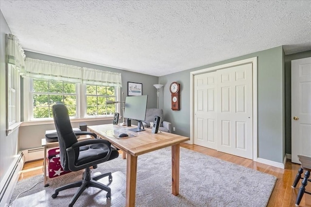 49 Karen Rd, Hanover, MA 02339 - office with wood finished floors, a baseboard heating unit, a textured ceiling, and baseboards