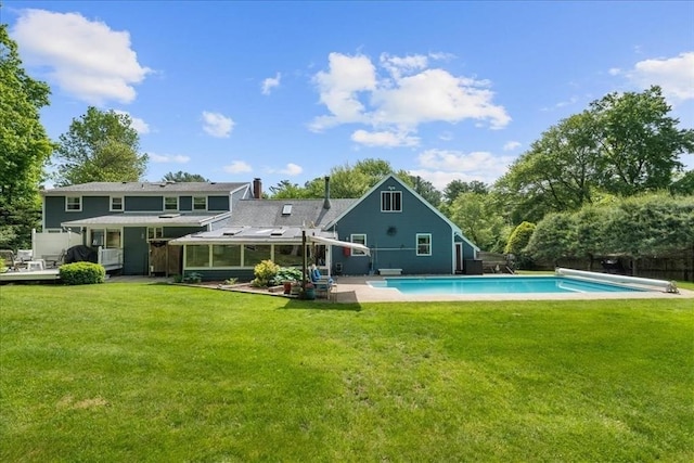 49 Karen Rd, Hanover, MA 02339 - rear view of property with a covered pool, a lawn, a chimney, a sunroom, and a patio