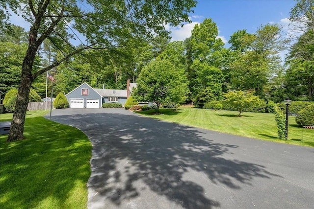 49 Karen Rd, Hanover, MA 02339 - view of front of home featuring asphalt driveway, view of wooded area, and a garage