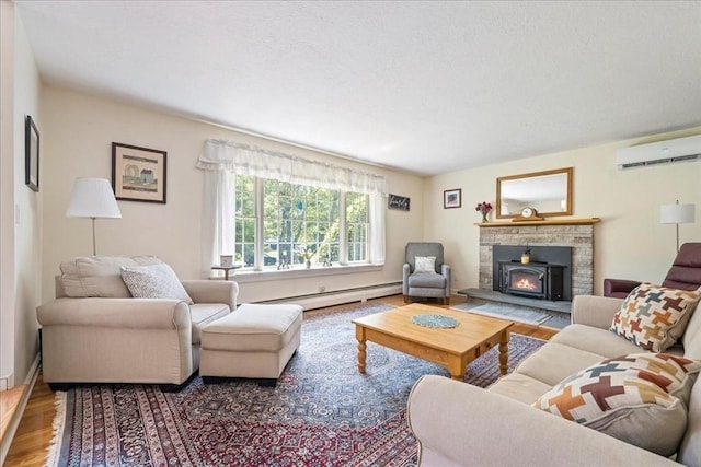 49 Karen Rd, Hanover, MA 02339 - living area with a wall unit AC, wood finished floors, baseboard heating, a textured ceiling, and a warm lit fireplace