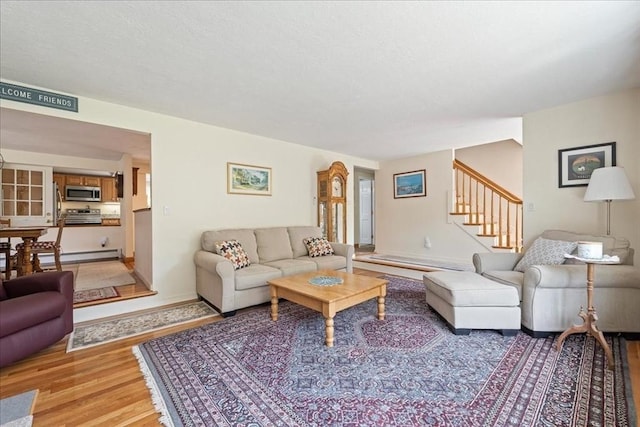 49 Karen Rd, Hanover, MA 02339 - living room with light wood-type flooring, stairs, baseboards, and a textured ceiling