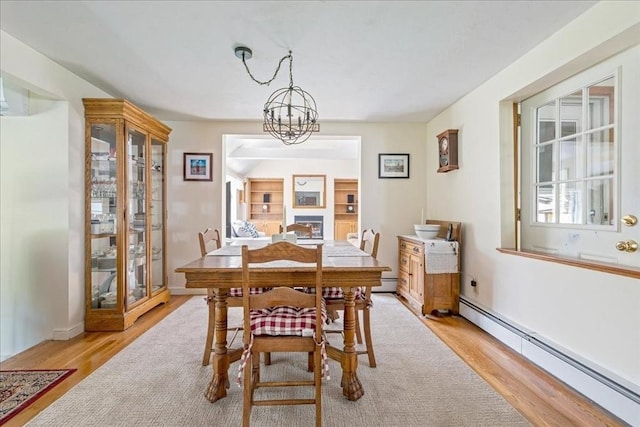 49 Karen Rd, Hanover, MA 02339 - dining room featuring a baseboard heating unit, light wood-style flooring, and a chandelier