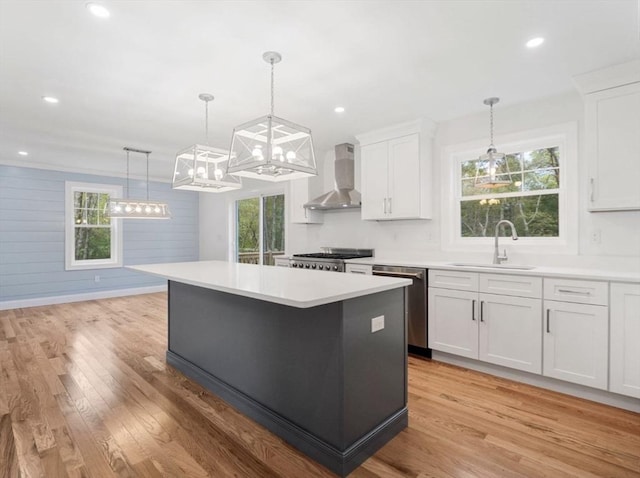316 Old Westport Rd, Dartmouth, MA 02747 - kitchen with a sink, wall chimney exhaust hood, stainless steel dishwasher, a kitchen island, and light countertops