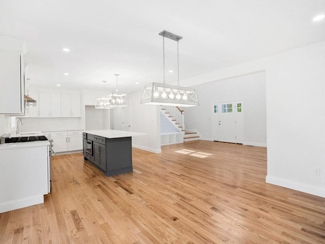 316 Old Westport Rd, Dartmouth, MA 02747 - kitchen with white cabinetry, hanging light fixtures, light wood-style floors, light countertops, and recessed lighting