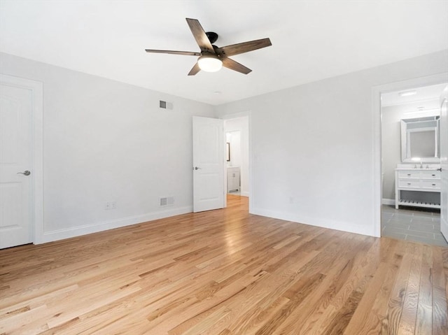 316 Old Westport Rd, Dartmouth, MA 02747 - unfurnished bedroom with light wood finished floors, baseboards, ensuite bathroom, and ceiling fan