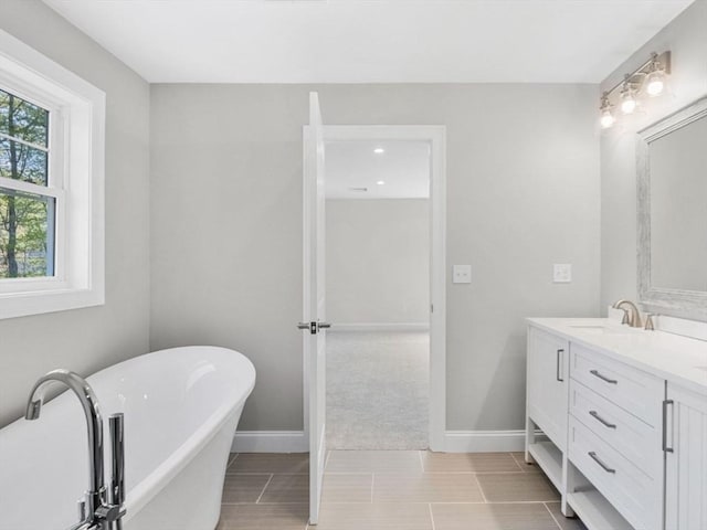 316 Old Westport Rd, Dartmouth, MA 02747 - full bathroom with double vanity, a soaking tub, and baseboards