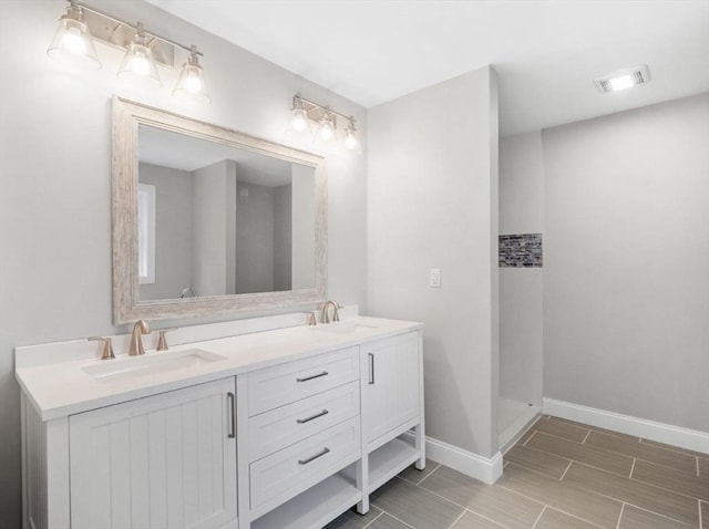 316 Old Westport Rd, Dartmouth, MA 02747 - full bathroom with double vanity, baseboards, a shower, and wood tiled floors