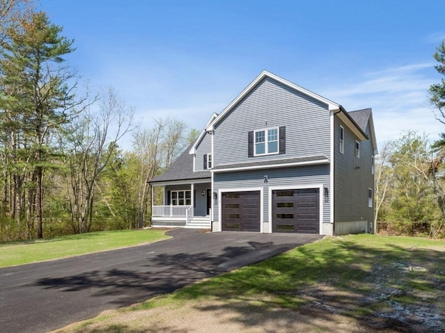 316 Old Westport Rd, Dartmouth, MA 02747 - view of front facade with covered porch, driveway, a garage, and a front yard