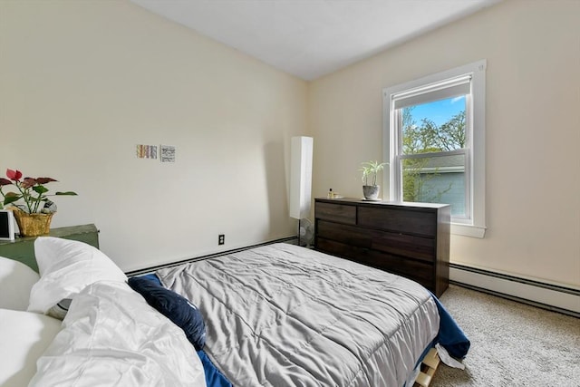 bedroom featuring a baseboard heating unit and carpet floors
