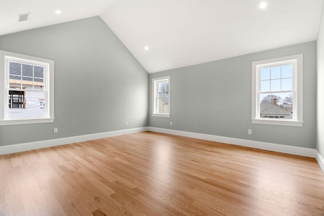 interior space with plenty of natural light, recessed lighting, light wood-style flooring, and vaulted ceiling