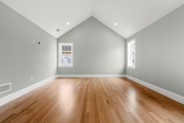 empty room featuring visible vents, lofted ceiling, baseboards, recessed lighting, and light wood-style flooring
