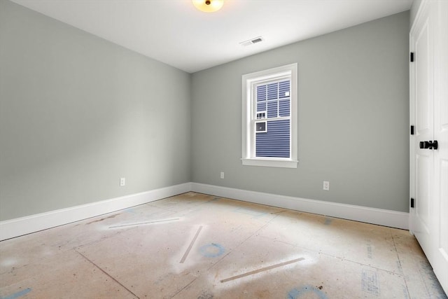 unfurnished room with baseboards and visible vents