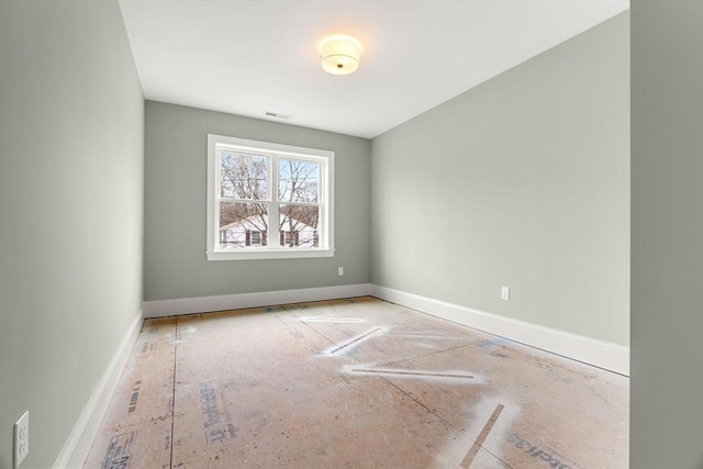 spare room with baseboards