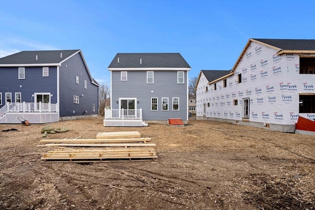 back of property featuring a wooden deck
