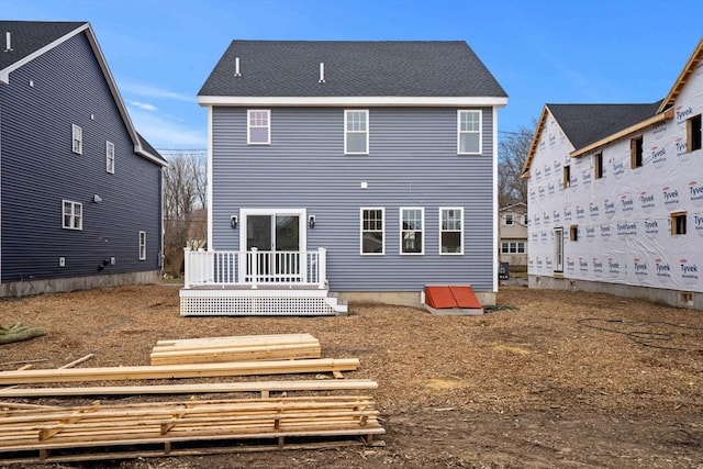 back of house with a deck