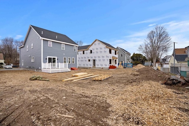 back of property featuring a deck and a residential view