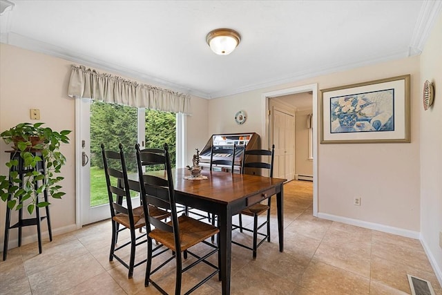 dining room with crown molding, a baseboard radiator, baseboards, and visible vents