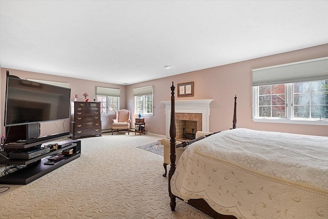 carpeted bedroom with baseboards and a fireplace
