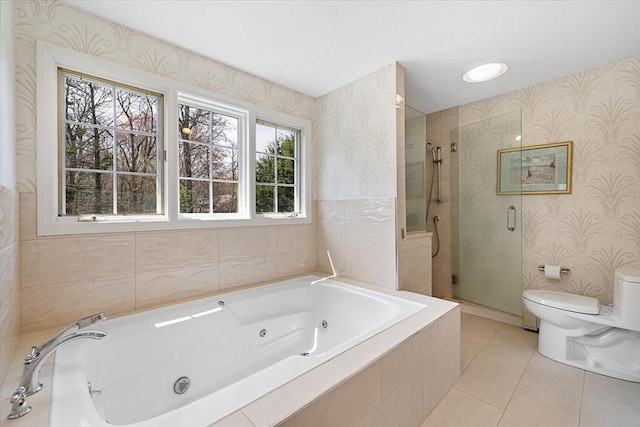 bathroom with tile patterned flooring, toilet, wallpapered walls, a tub with jets, and a stall shower