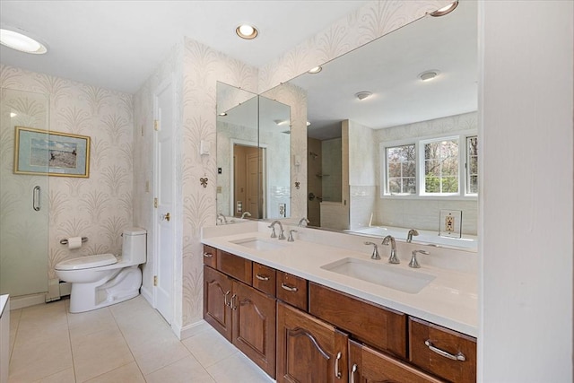 bathroom with a sink, tile patterned floors, baseboards, and toilet