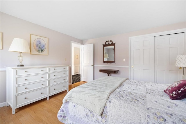 bedroom featuring a closet and light wood-type flooring