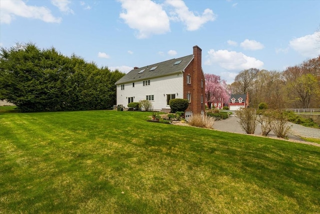 exterior space with a lawn and a chimney