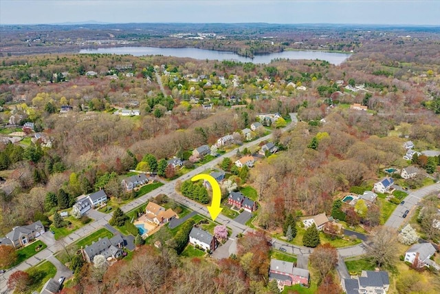 birds eye view of property featuring a water view, a residential view, and a forest view